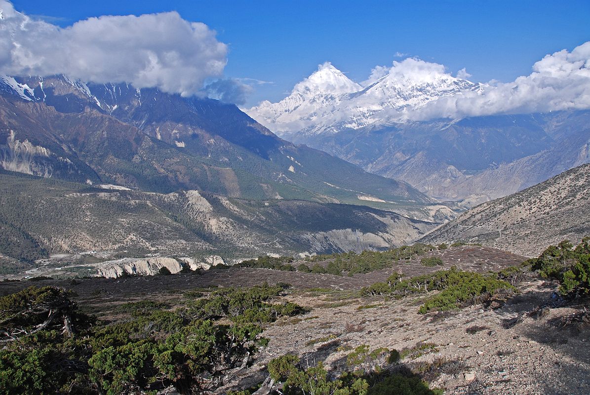 11 Dhaulagiri And Tukuche Peak Early Morning On Trail To Mesokanto La I turned around on the trail towards Mesokanto La and watched the clouds boil up towards Dhaulagiri and Tukuche Peak. The trail continues up the side of the valley from the kharka (3460m) and then splits in two  the left going to the Tilicho eastern pass (5200m), while we took the right path to try and cross the Mesokanto La (5100m).